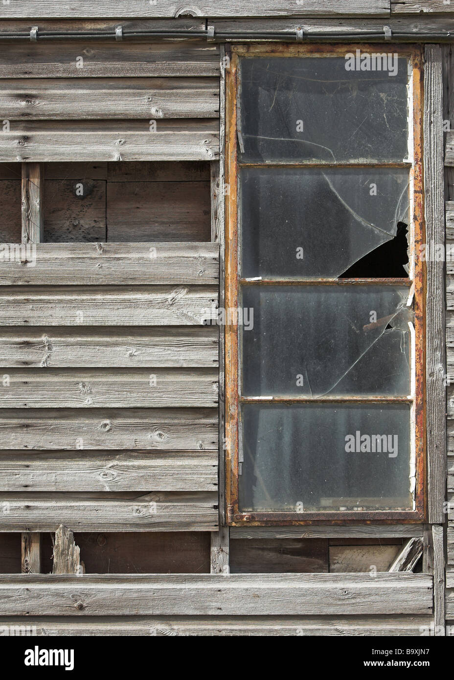 Old abandoned wooden building with broken windows Stock Photo - Alamy