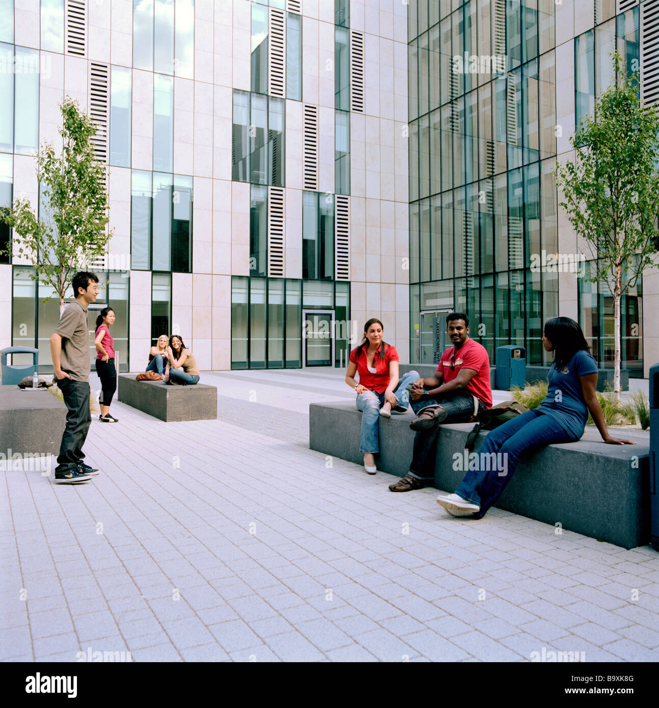 University campus, building, young students hanging out, taking it easy in between class and lectures Stock Photo
