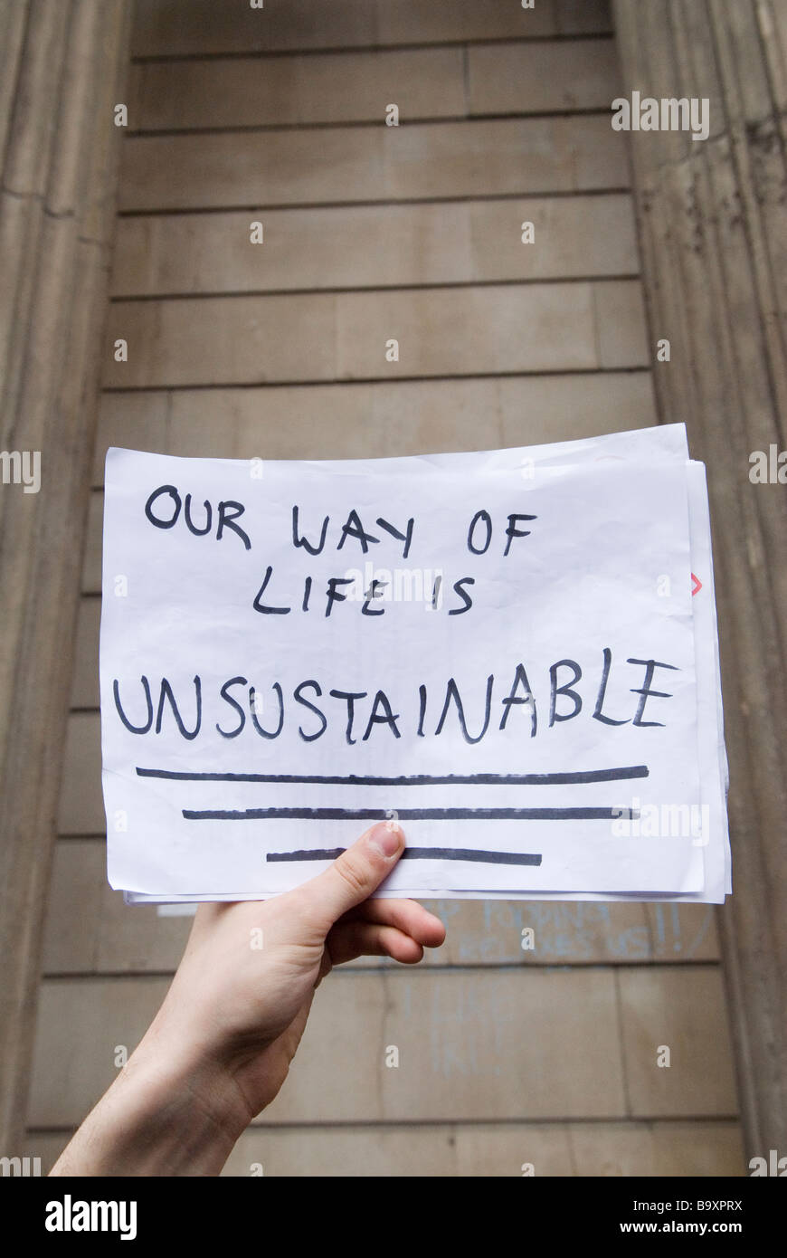 hand holding notice Our way of Life is Unsustainable London UK Stock Photo