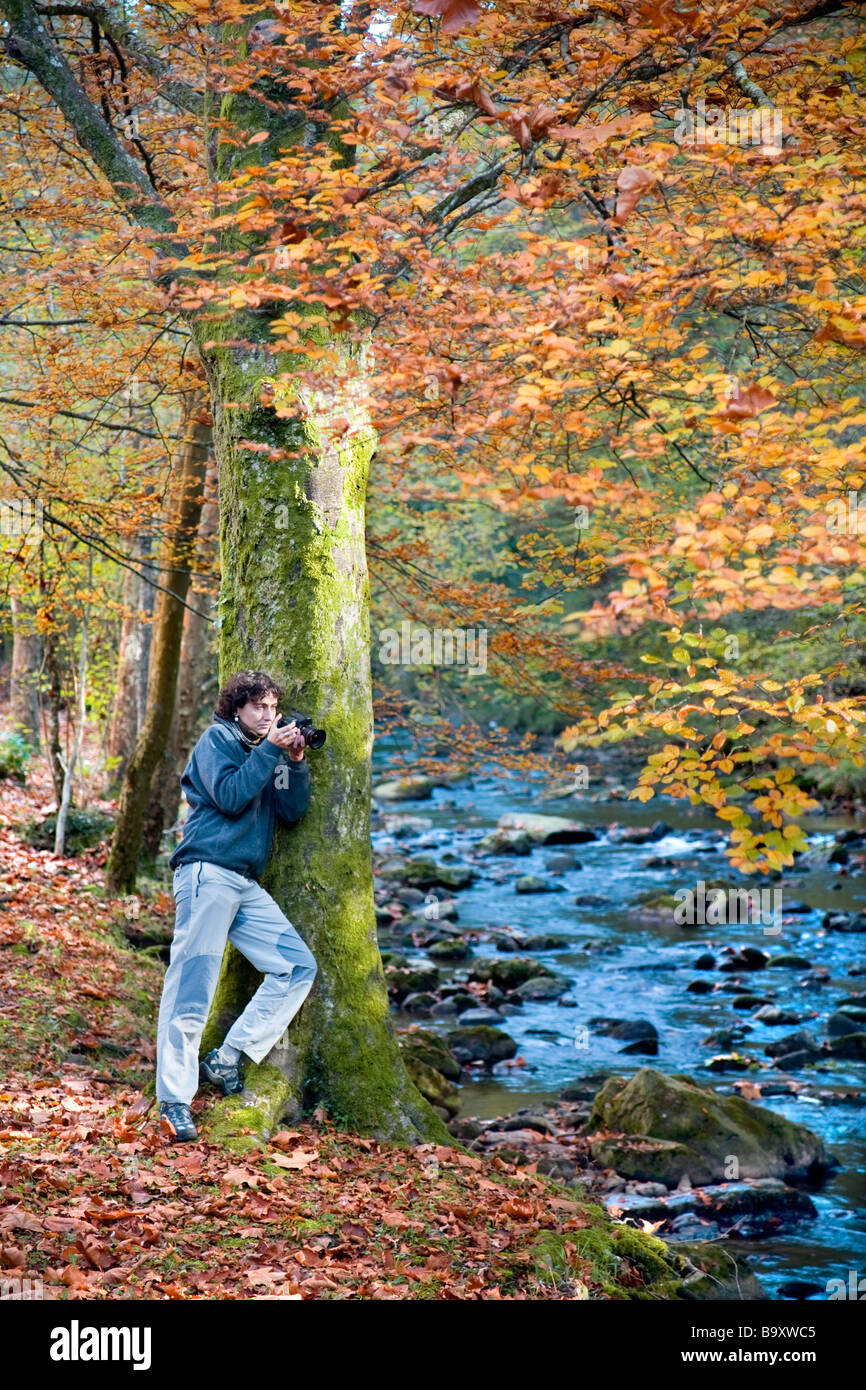 young woman taking photos in a forest in autumn Stock Photo - Alamy