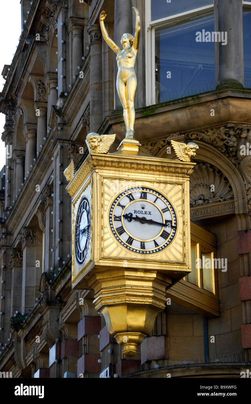 large external gold clock and stature of a lady Stock Photo