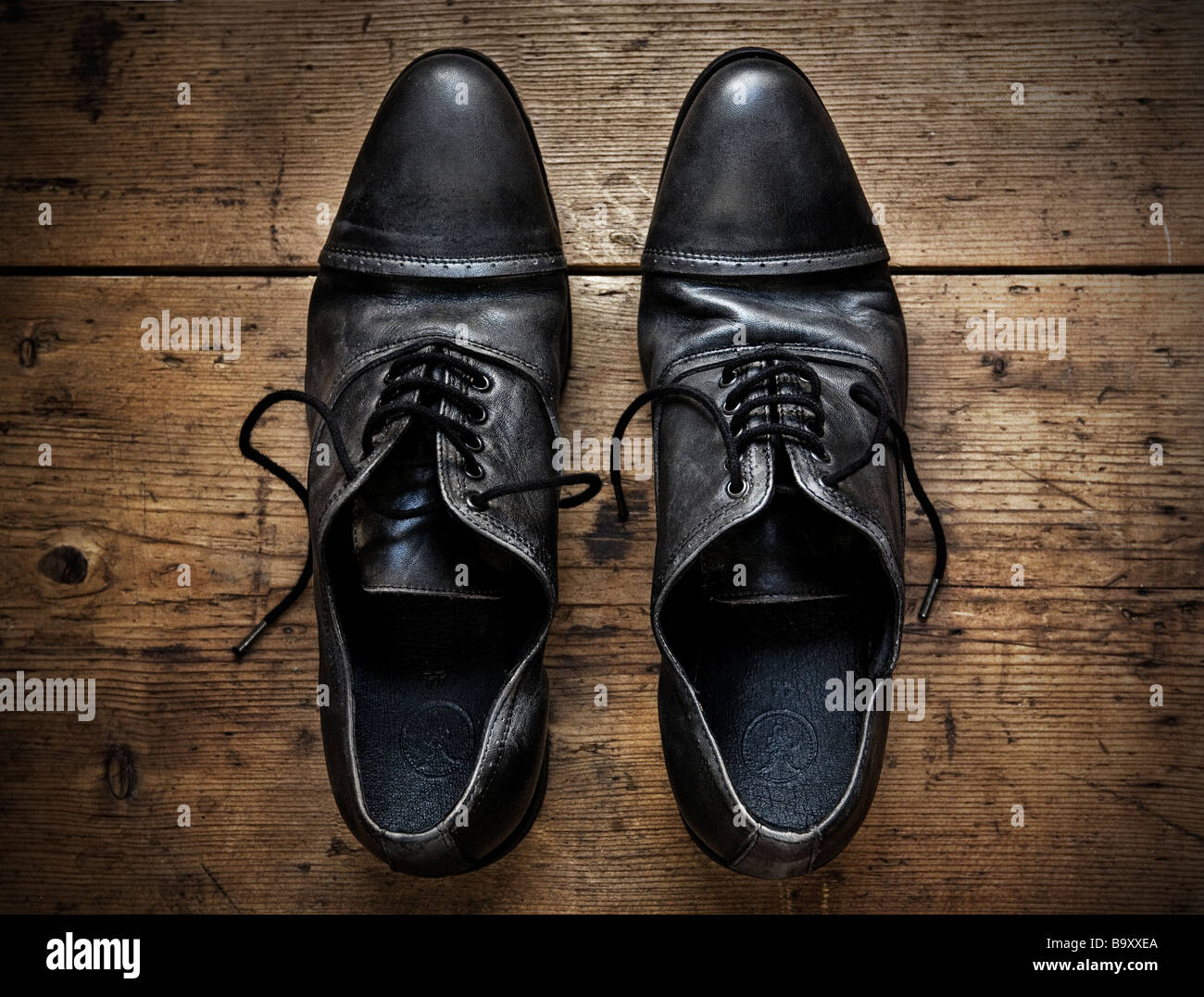 Old Shoes on a wooden table Stock Photo - Alamy