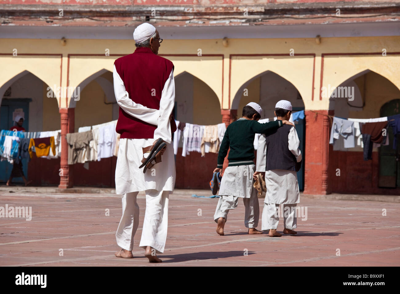 Teacher Watching Over Boys at the Fatehpuri Mosque in Old Delhi India Stock Photo