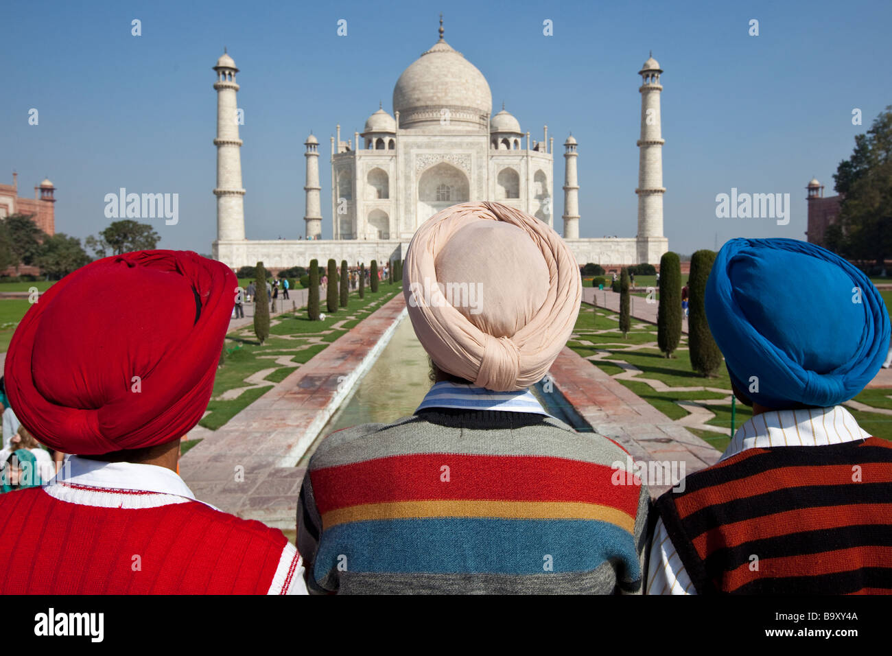 Three Indian Sikh Men at the Taj Mahal in Agra India Stock Photo