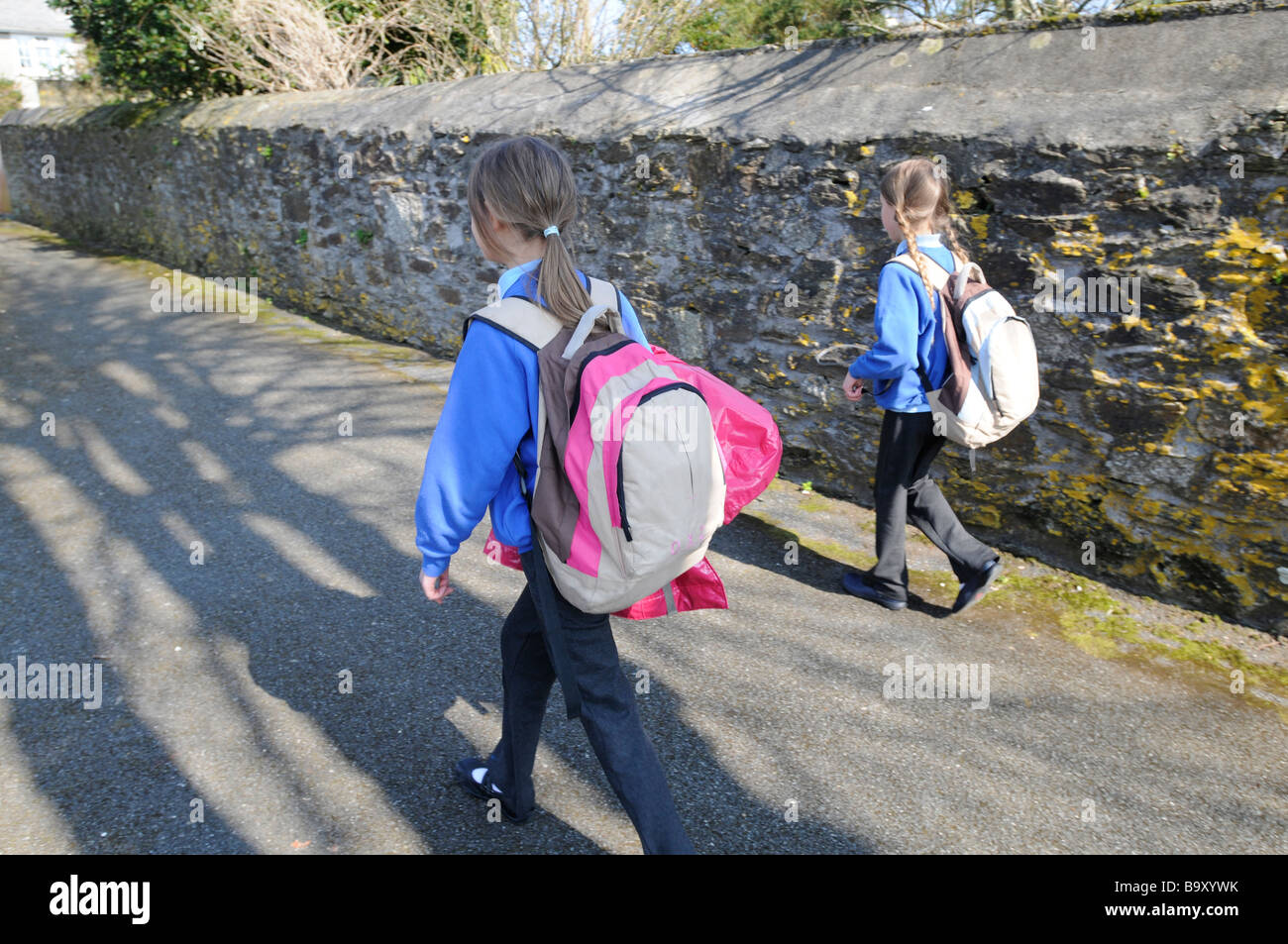 Two sisters returning from school. Stock Photo