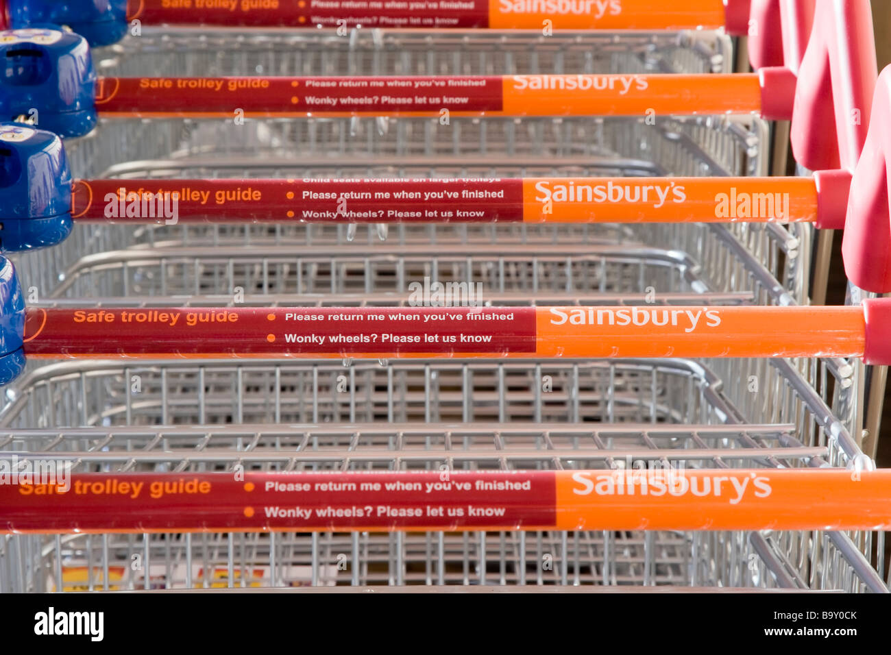 A row of Sainsbury's supermarket trolleys Stock Photo
