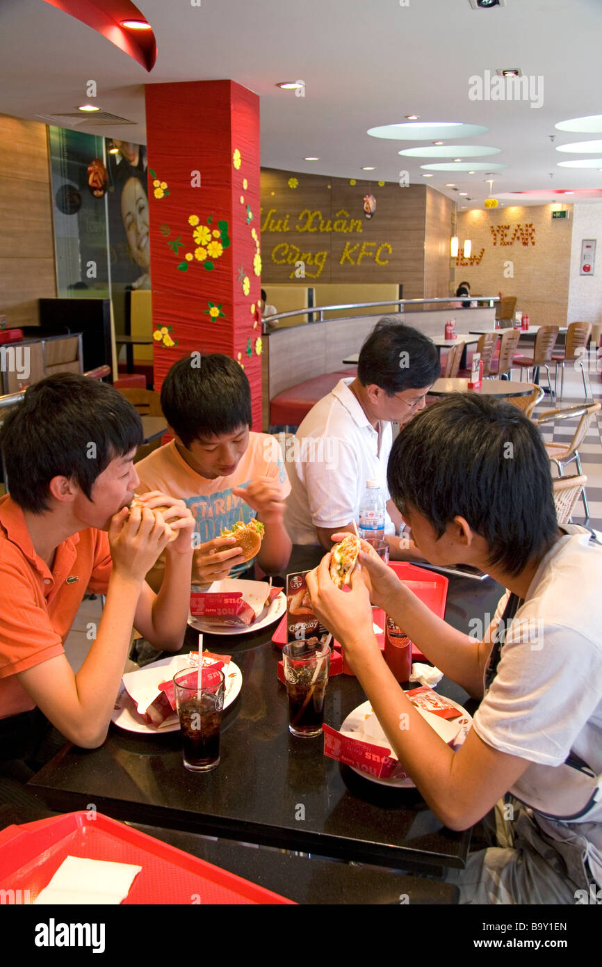 Vietnamese people eat at a KFC restaurant inside the Diamond Plaza shopping center in downtown Ho Chi Minh City Vietnam Stock Photo