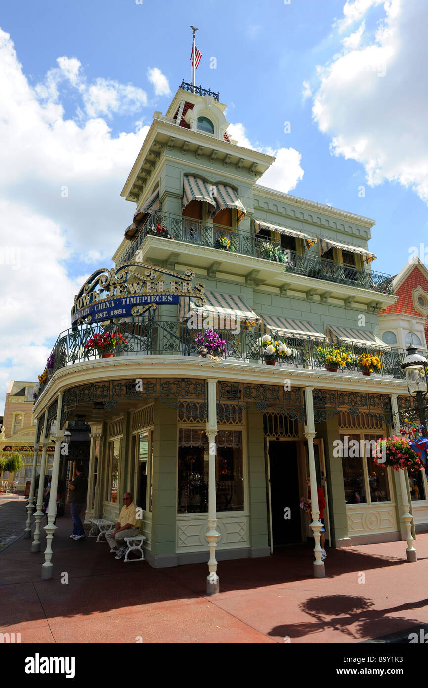 Store with flowers in window boxes along Main Street at Walt Disney Magic Kingdom Theme Park Orlando Florida Central Stock Photo
