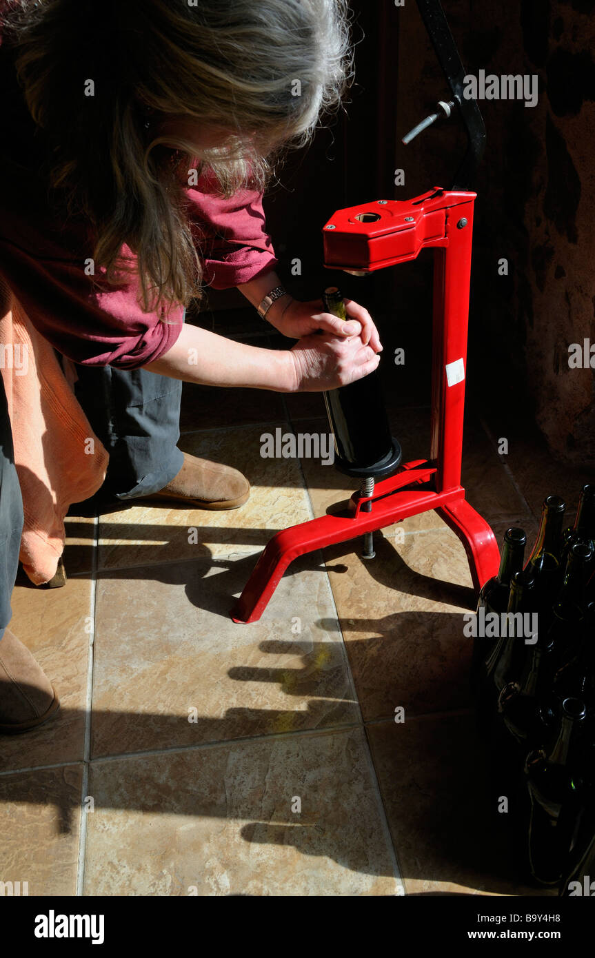 Woman corking bottles of wine Stock Photo Alamy