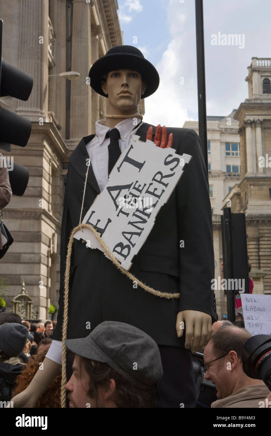 Anti Globalization protestors parade a dummy dressed up as a banker past The Bank of England Stock Photo