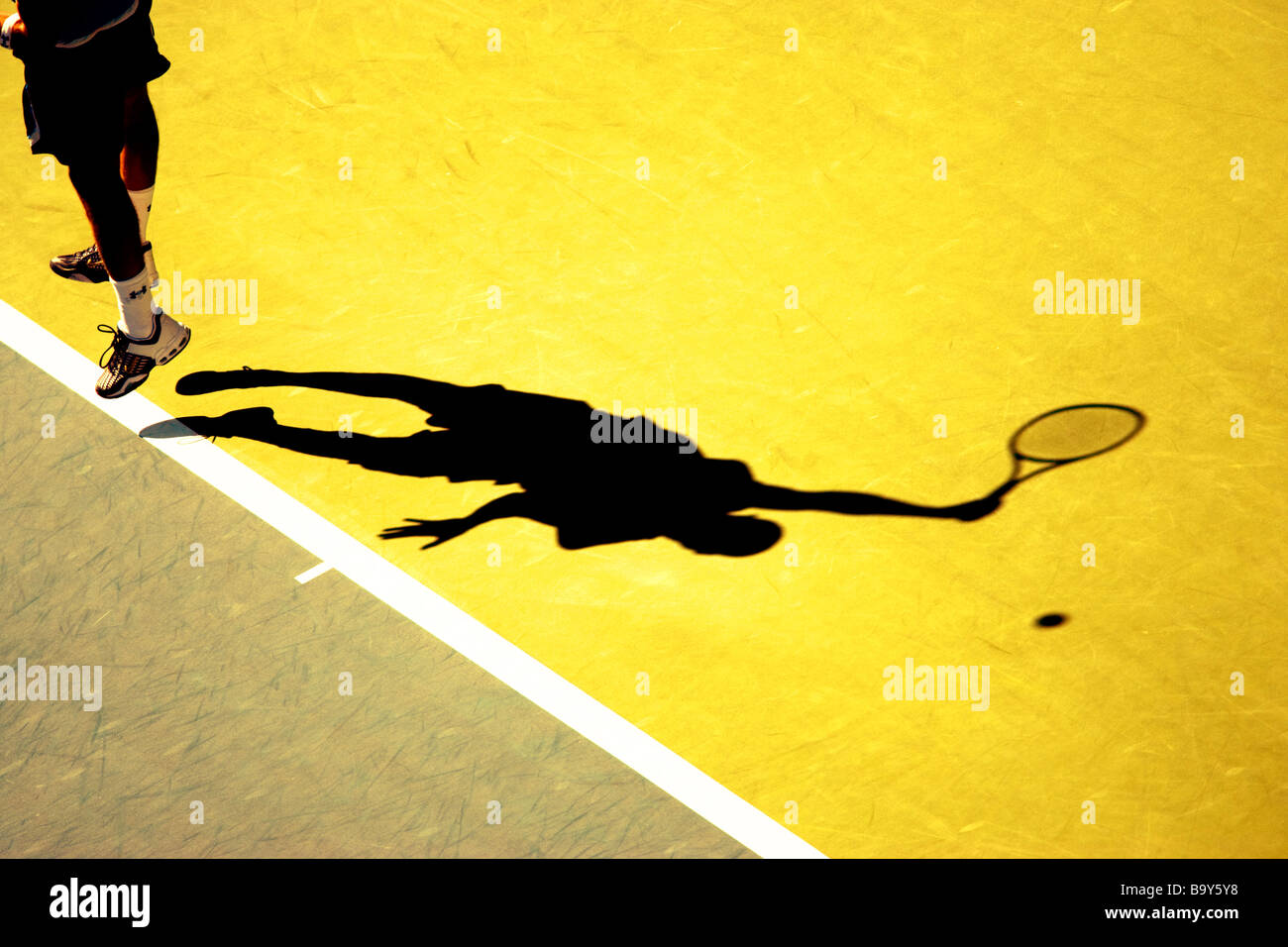 Shadow of tennis player serving Stock Photo Alamy