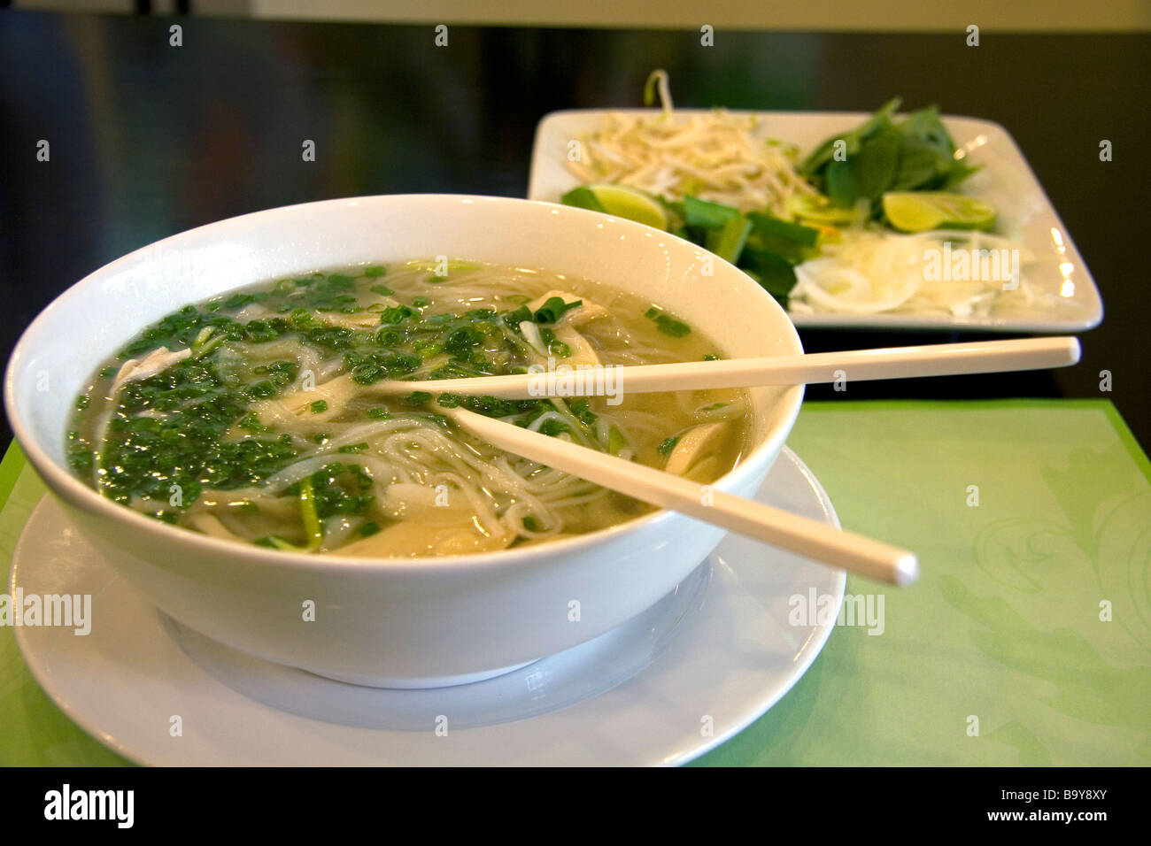 A bowl of Pho Vietnamese rice noodle soup at a restaurant in Ho Chi Minh City Vietnam Stock Photo