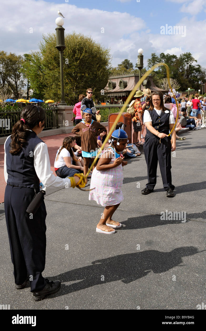 Child with Mouse Ears jumping rope at Walt Disney Magic Kingdom Theme Park Orlando Florida Central Stock Photo