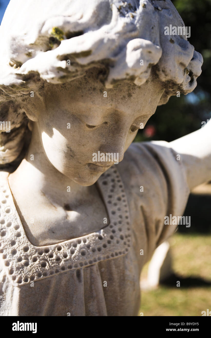 Angle shaped old headstone of a grave carved from marble Stock Photo