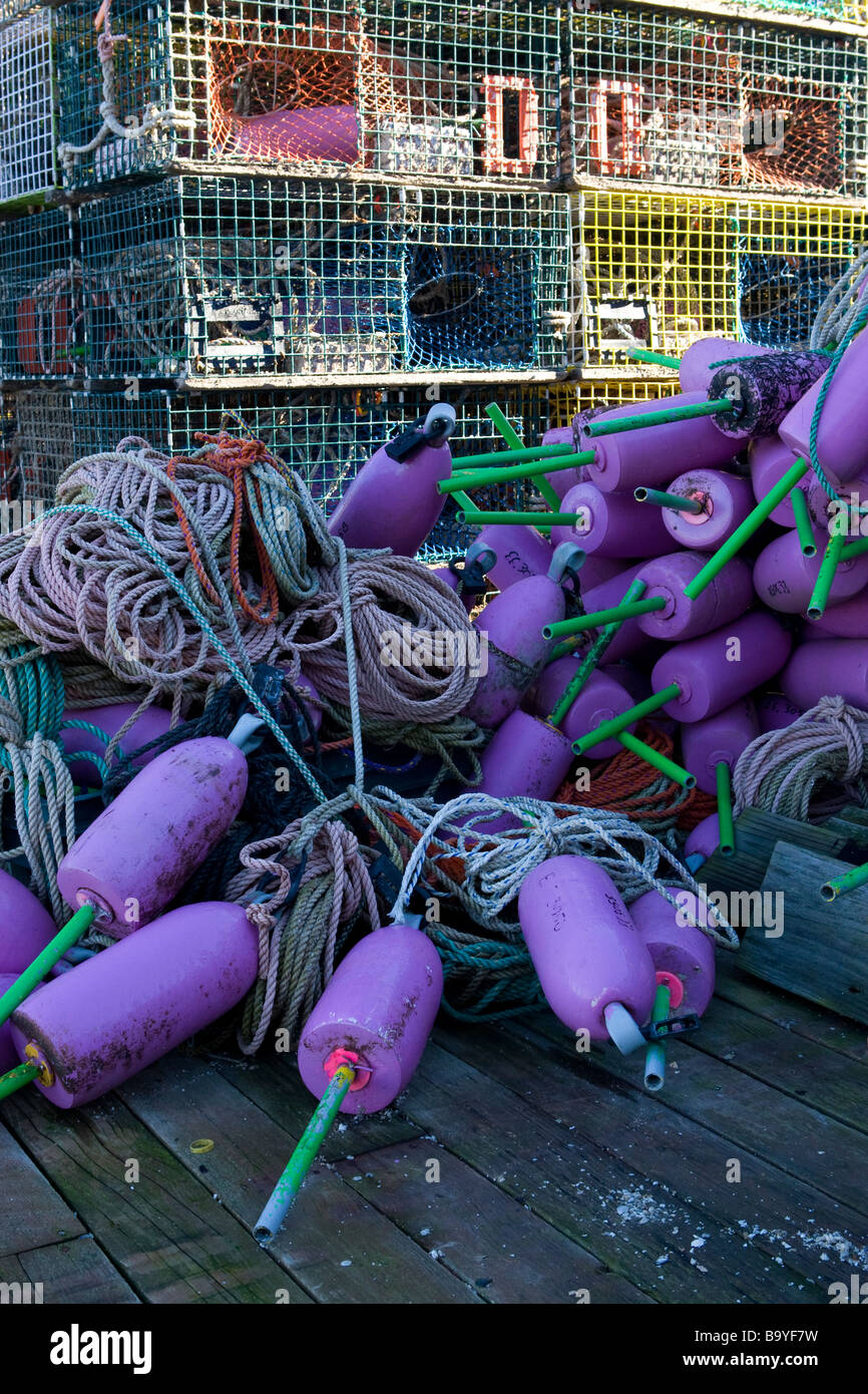 Lobster traps buoys and rope coils on a dock in coastal Maine Stock