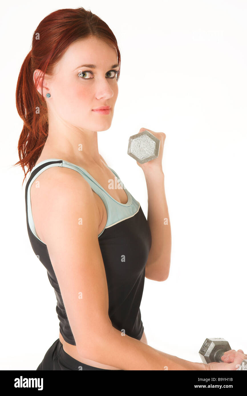A woman in gym clothes training with weights Stock Photo Alamy