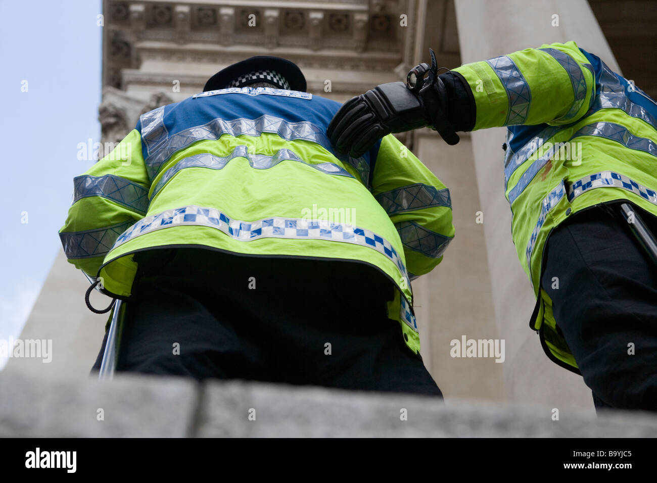 Two police officers stand guard during protests in City of London against G20 summit, April 1 2009 Stock Photo