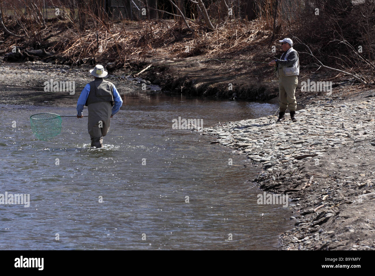 Men fishing in sixteen mile creek for steelhead trout in North East