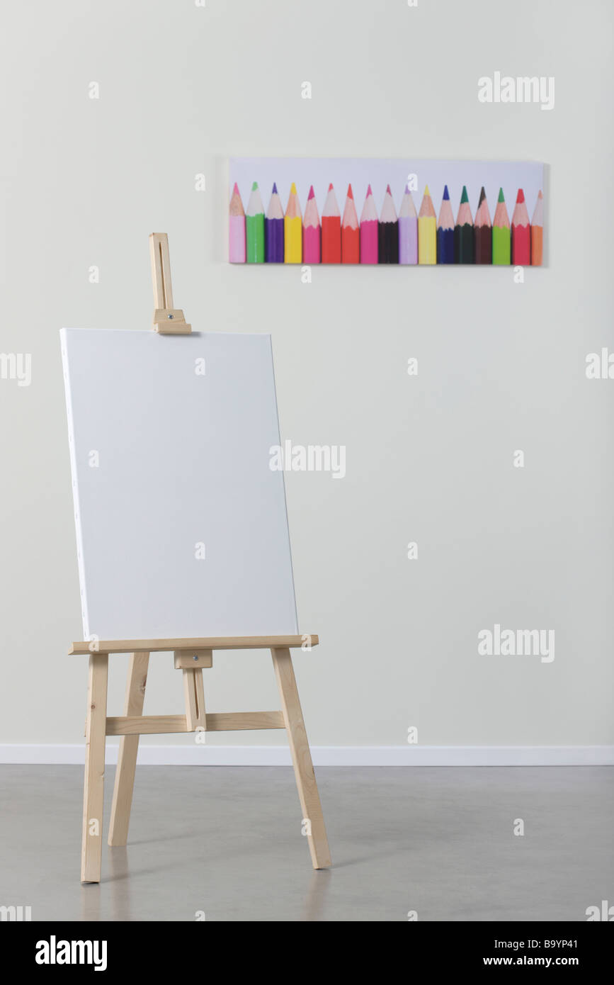 Painting stand wooden easel with blank canvas poster sign board Stock Photo