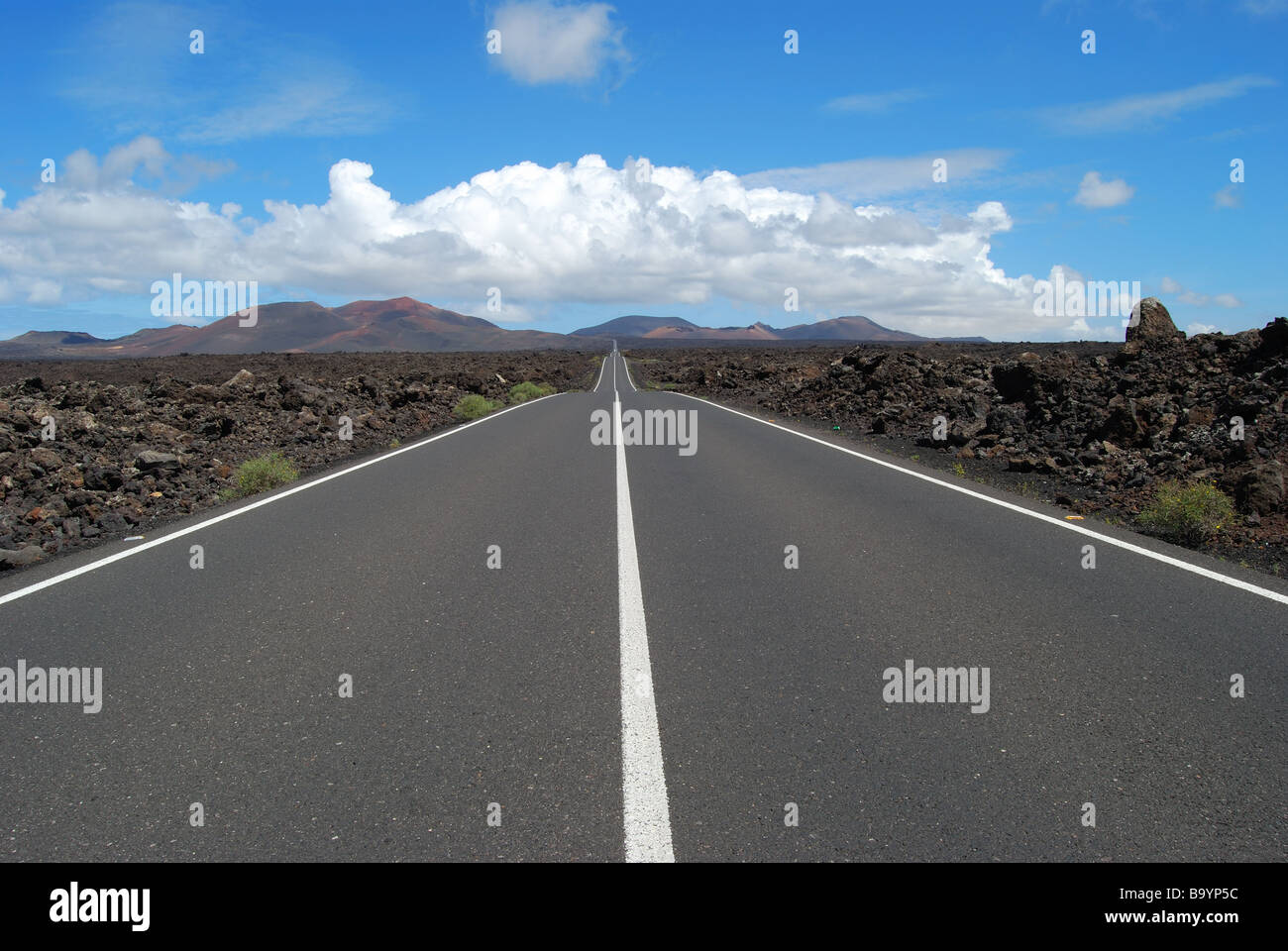 Road through volcanic lava, Timanfaya National Park, Lanzarote, Canary Islands, Spain Stock Photo