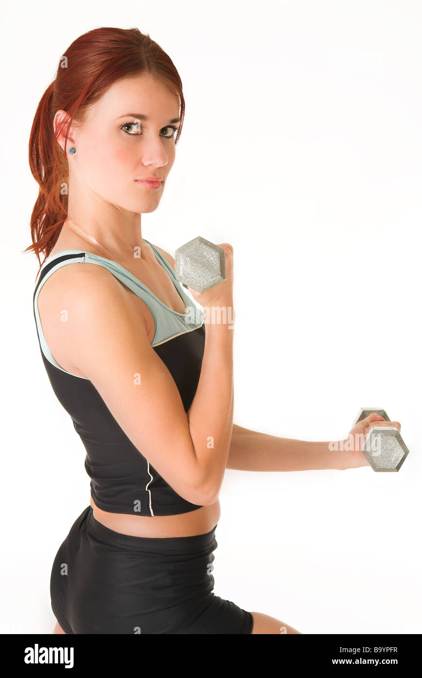 A woman in gym clothes training with weights Stock Photo Alamy