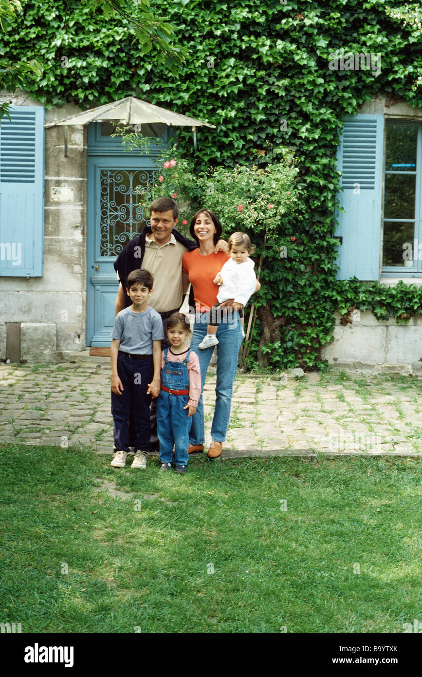 Family standing in front of house, portrait Stock Photo - Alamy