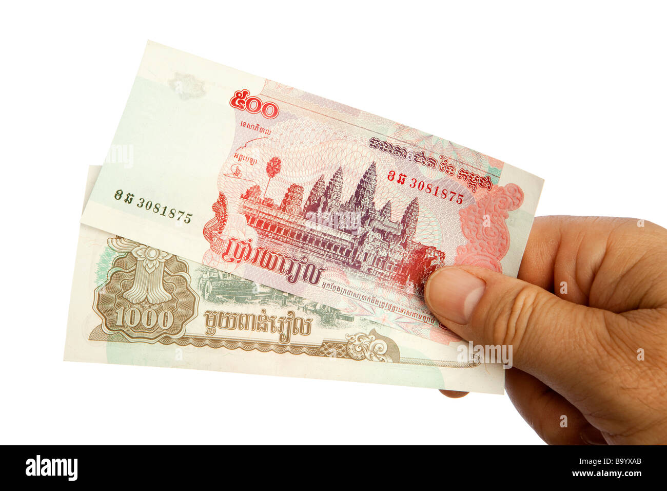 Money male hand holding handful of Cambodian currency Stock Photo