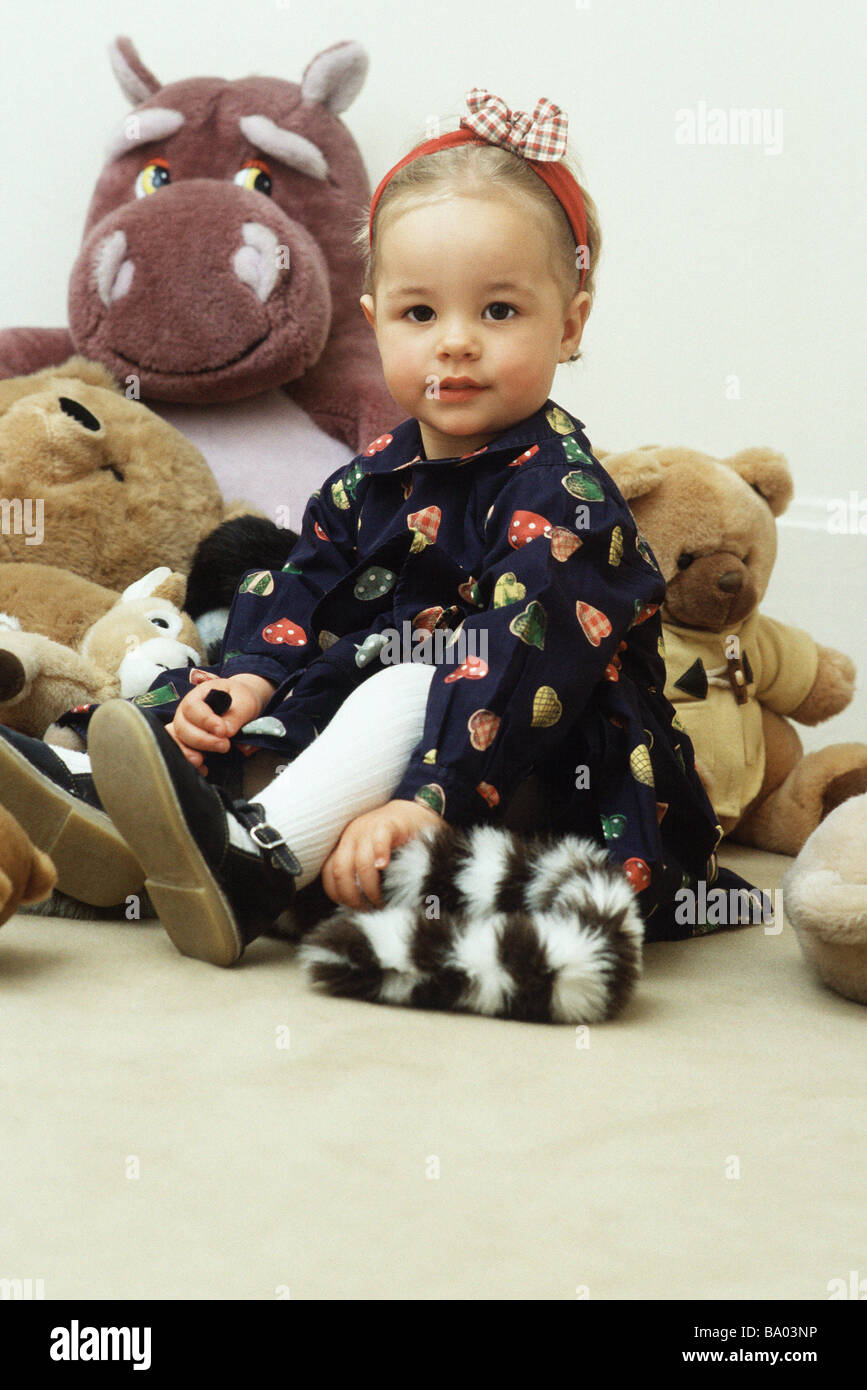 Little girl sitting with stuffed animals, portrait Stock Photo