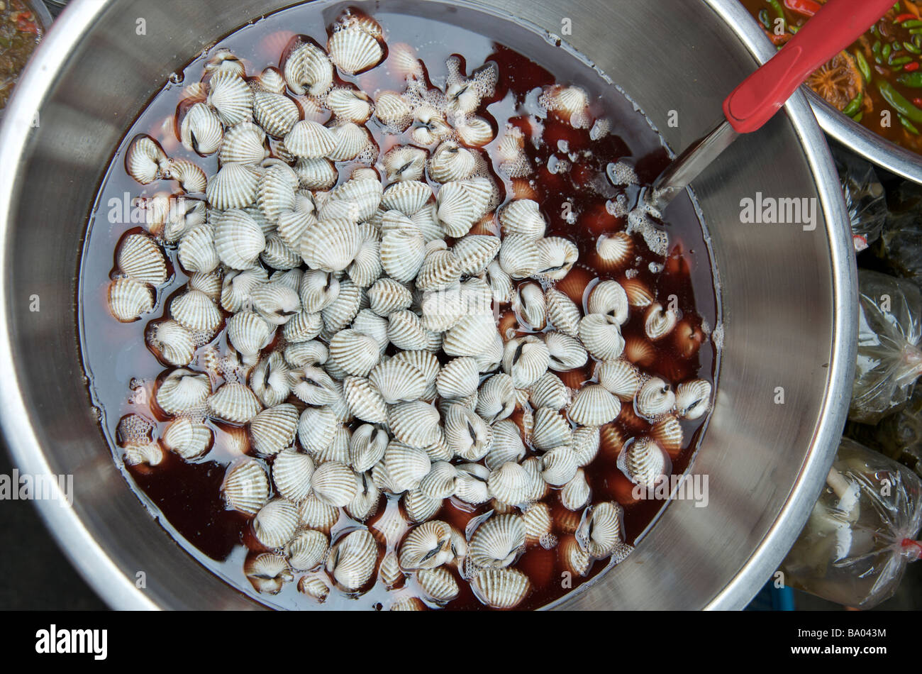 Close up of spicy chilli clams on a Bangkok street stall Thailand Stock Photo