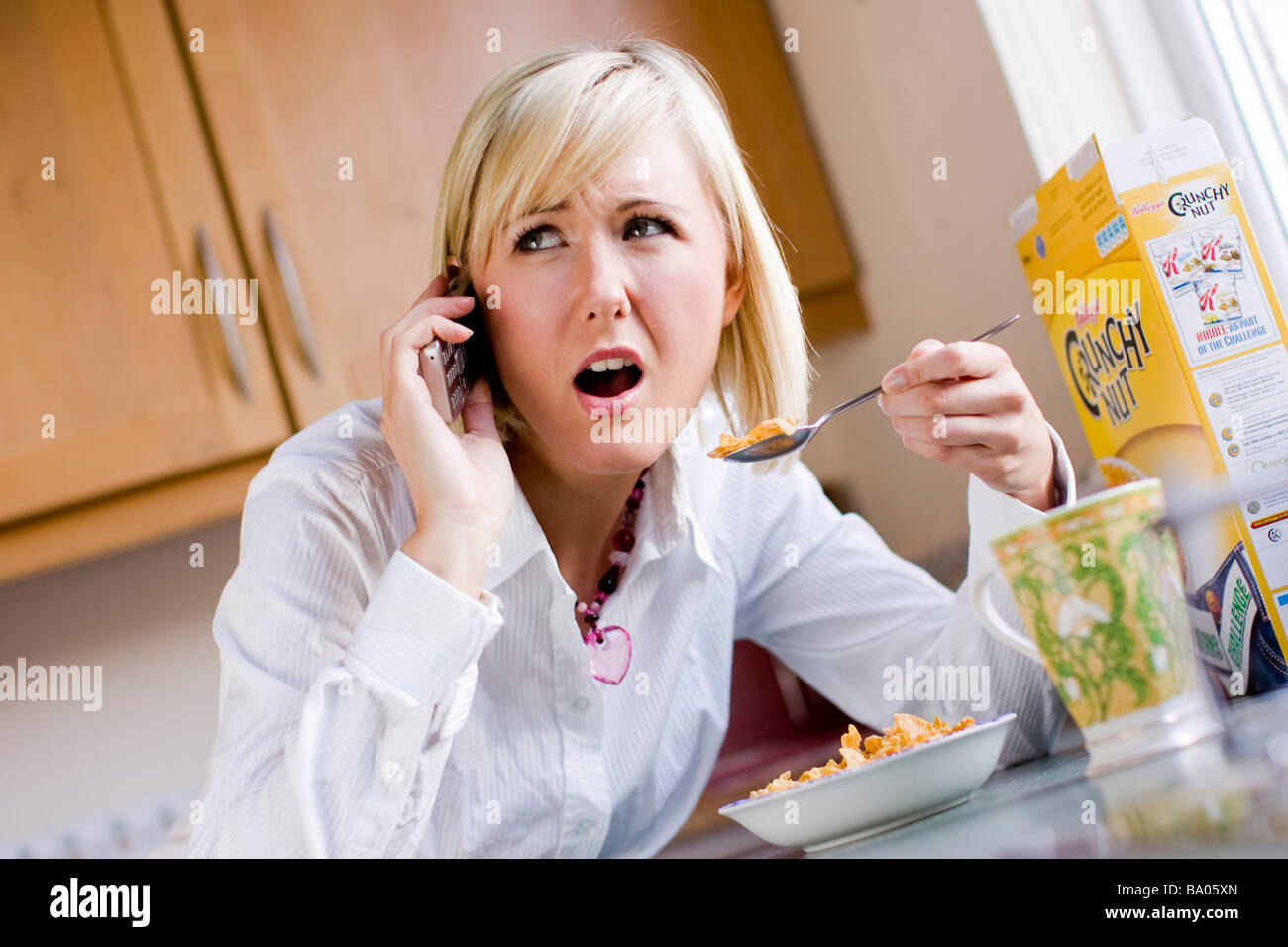 Woman stressed talking on mobile phone Stock Photo
