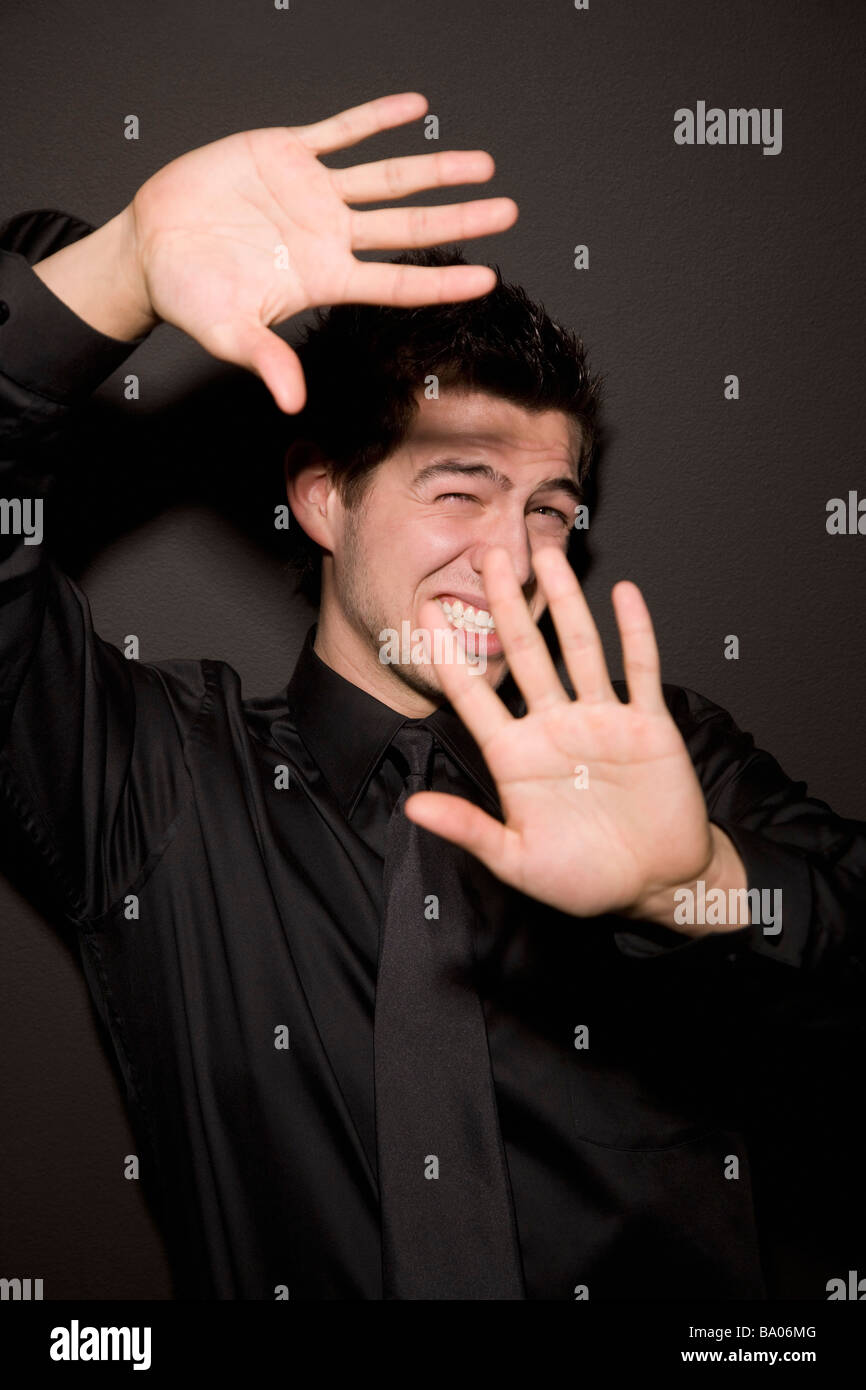 Man with hands blocking light Stock Photo