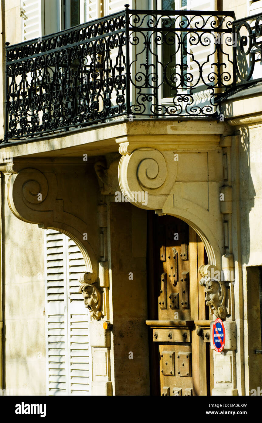 Railing, architectural detail of mens faces and facade surrounding a ...