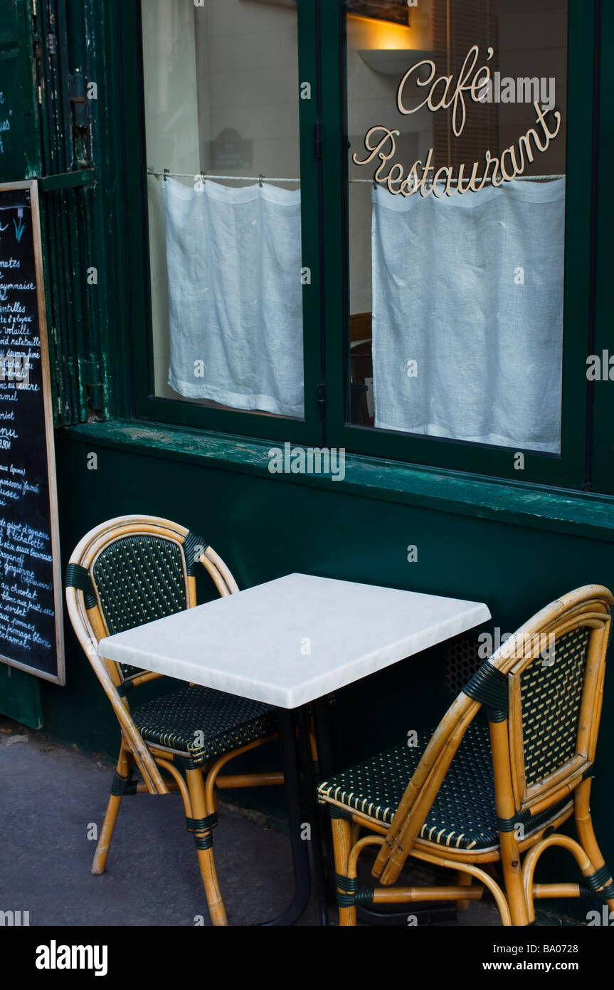 Cafe window, table and wicker chairs in the Latin Quarter in Paris