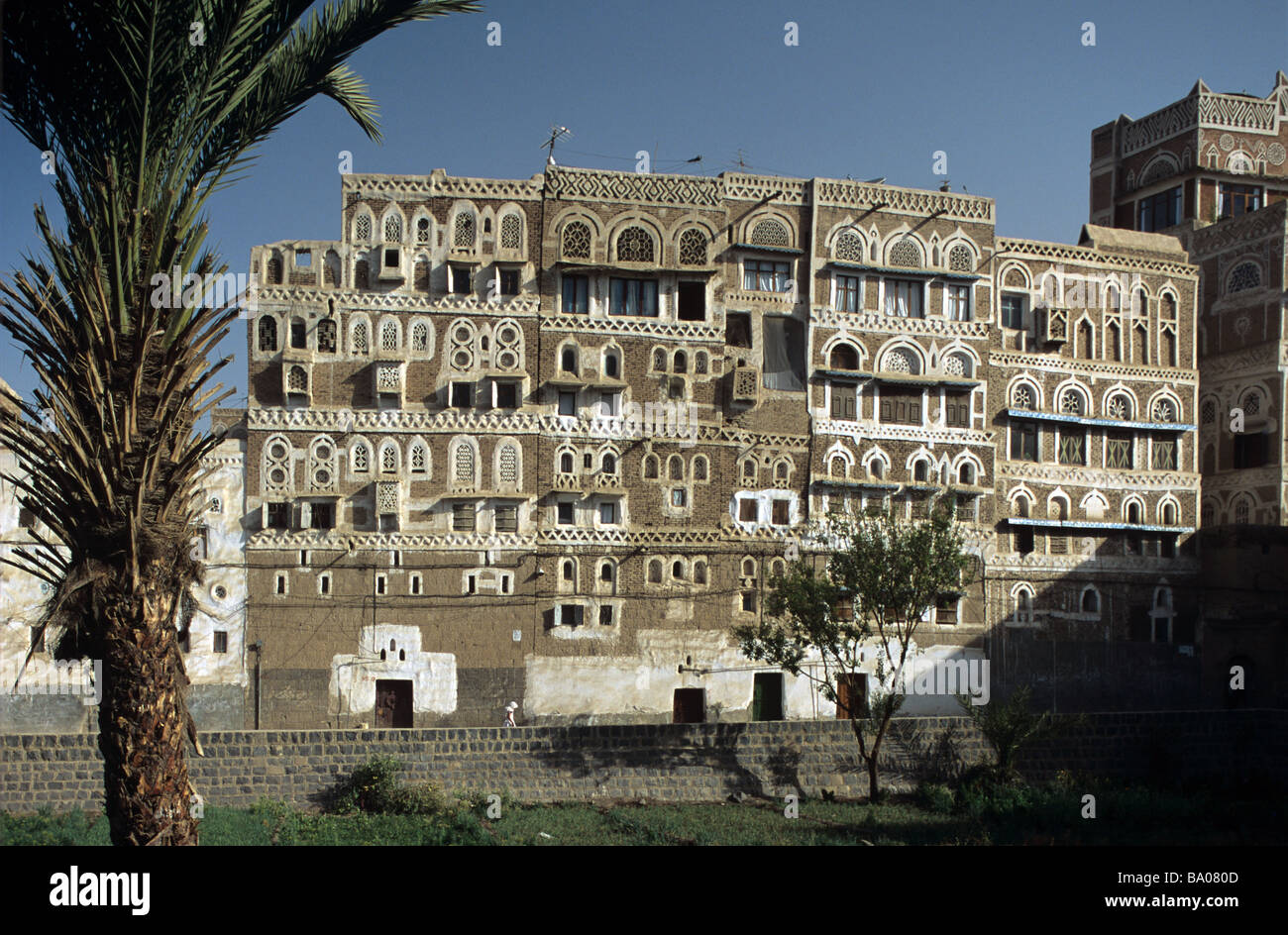 Adobe Mud Brick High-Rise Tower Houses with Decorated Windows, Sana'a or San'a, Capital of the Republic of Yemen Stock Photo