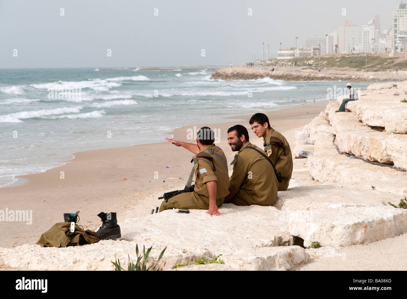 Young IDF soldiers relaxing on the waterfront in the south of Tel Aviv, Israel Stock Photo