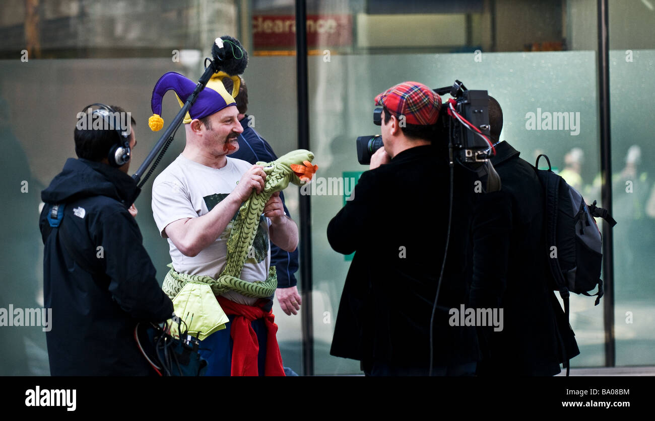 Protester being interviewed by a television crew at a demonstration in the City of London. Stock Photo