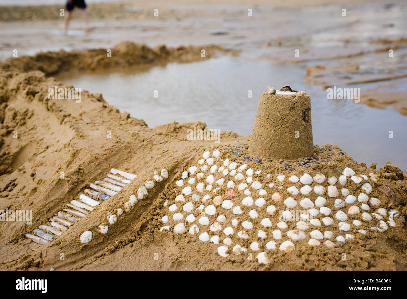Elaborately decorated sandcastle with a tower and monumental staircase