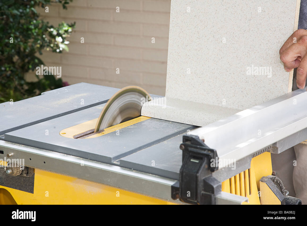 Carpenter Uses A Table Saw To Cut Laminate Counter Top Stock Photo
