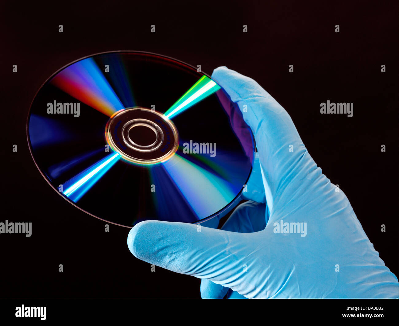 computer disc cd dvd in gloved hand Stock Photo