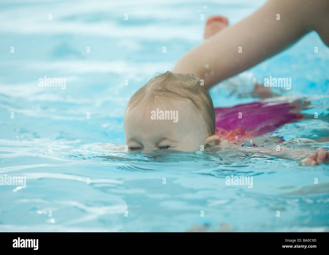 BABY SWIMMING LESSONS 15 MONTH OLD TODDLER GIRL ENJOYS LEARNING IN A