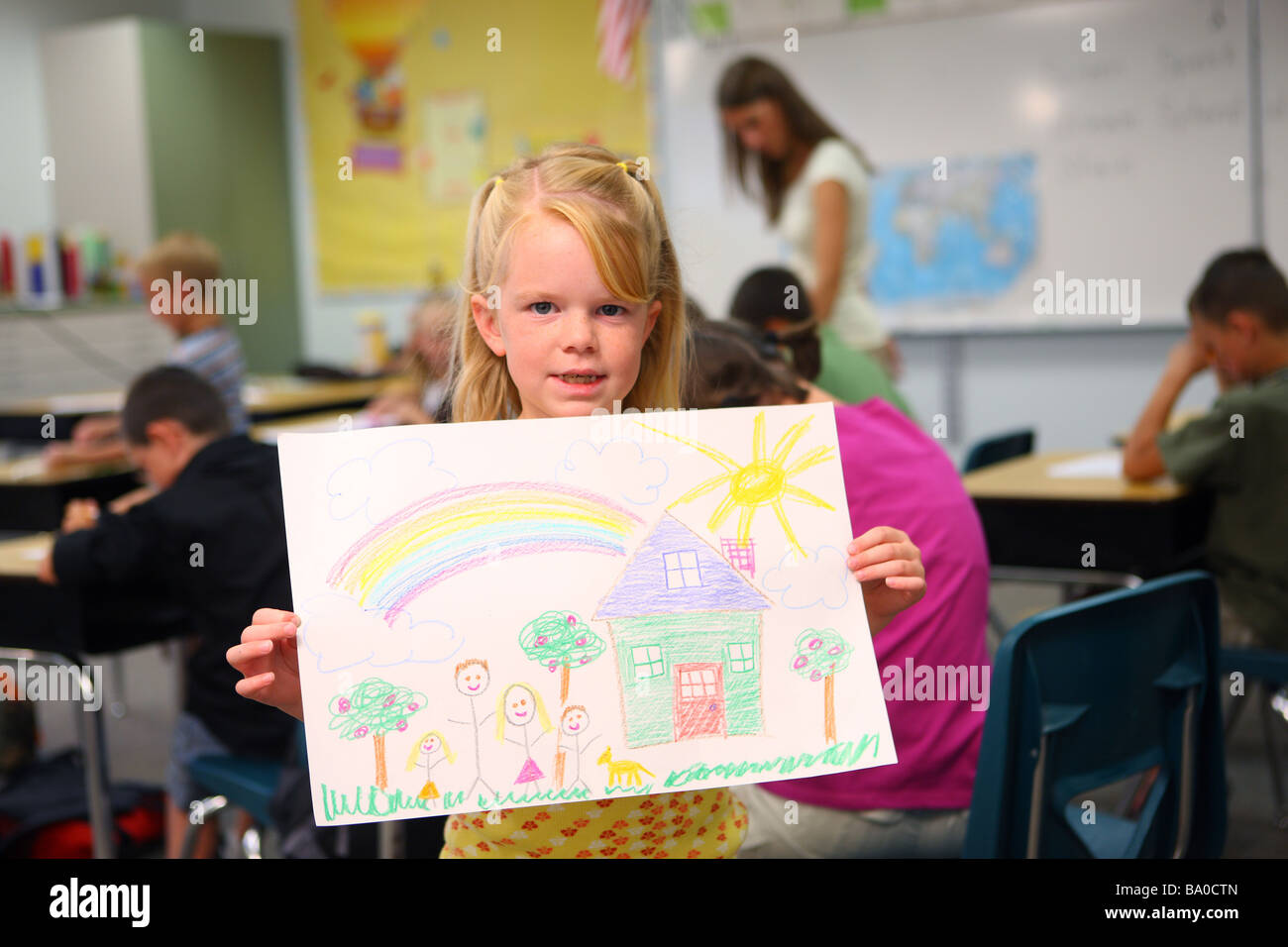 School girl holding up drawing Stock Photo