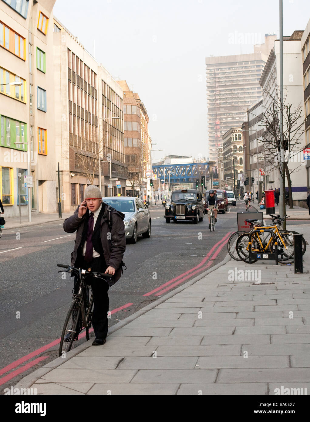 4th April 2009 London mayor Boris Johnson stops to take a phone call on his bicycle on Southwark Street Stock Photo