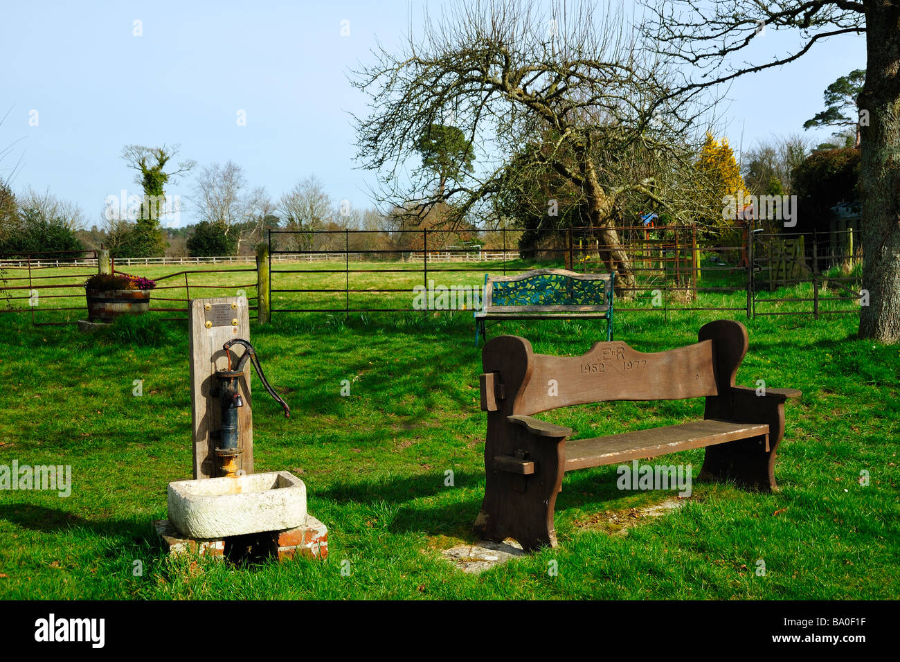 EAST HOLME, DORSET, UK - MARCH 16, 2009:  Silver Jubilee Commemorative Bench and Hand Pump Stock Photo