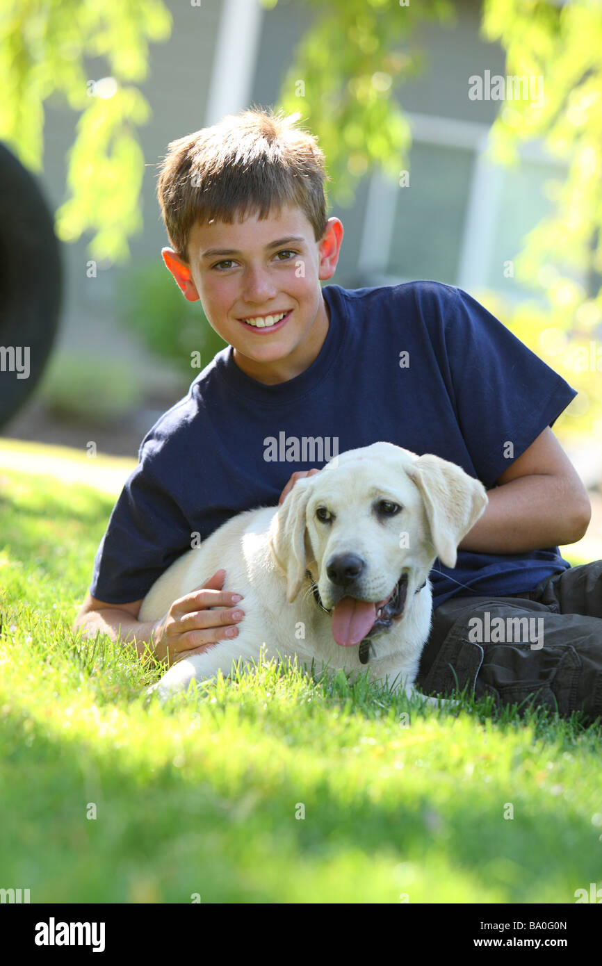 Young boy outdoors with puppy Stock Photo