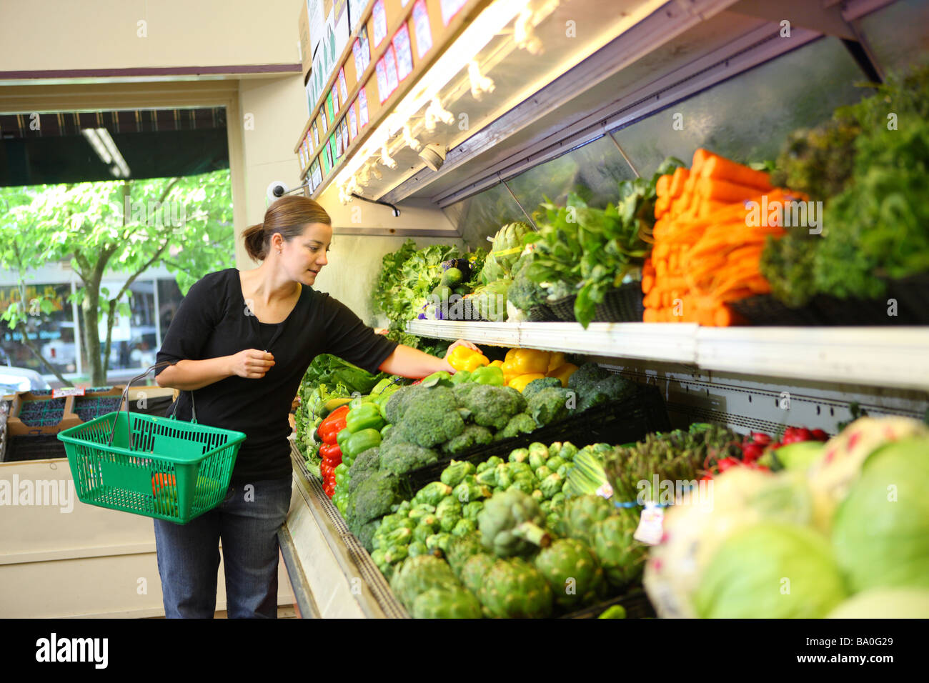 Woman shopping for produce in grocery store Stock Photo