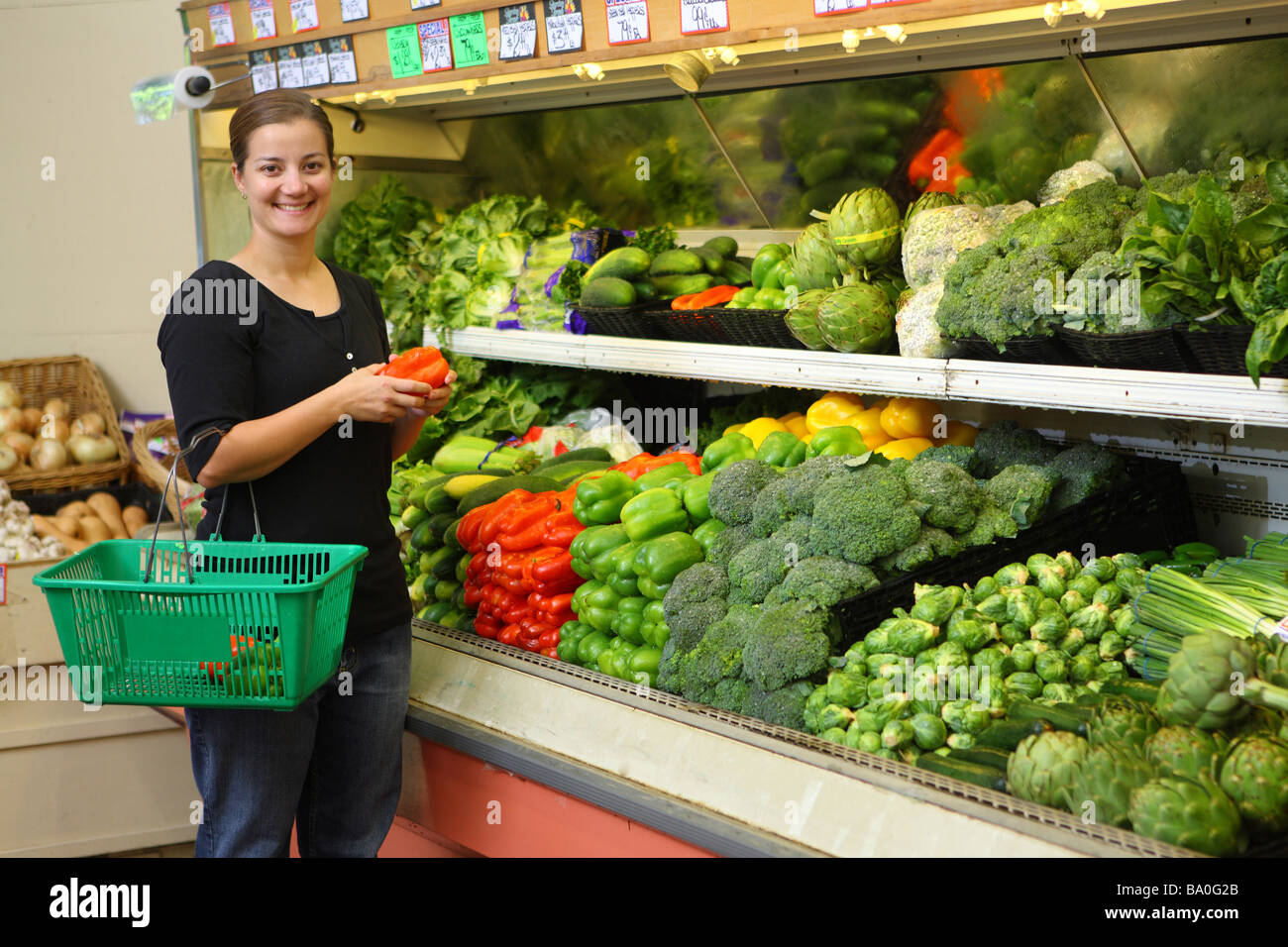 Young woman picking out vegetables in grocery store Stock Photo