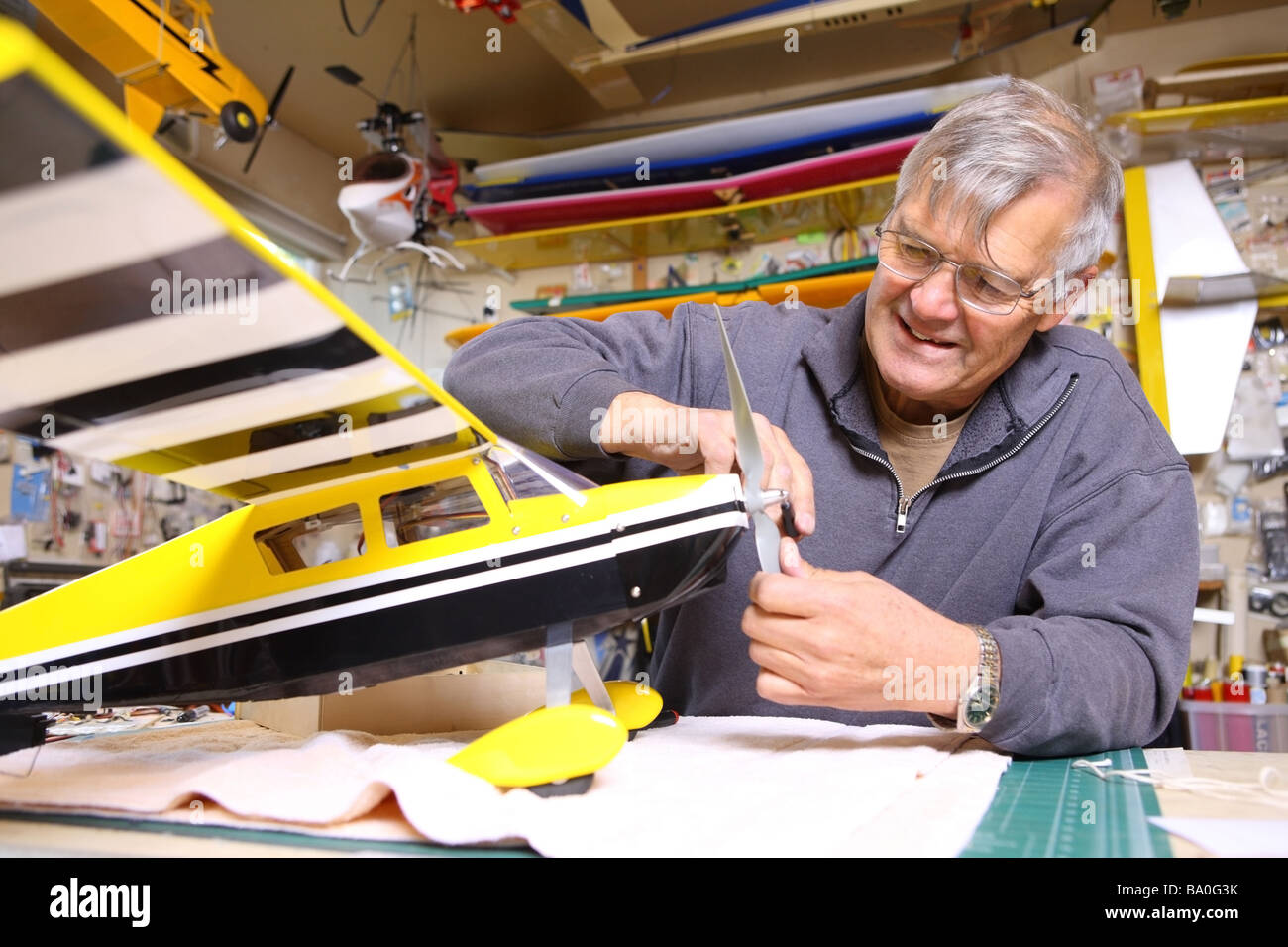 Senior man working on model airplane Stock Photo