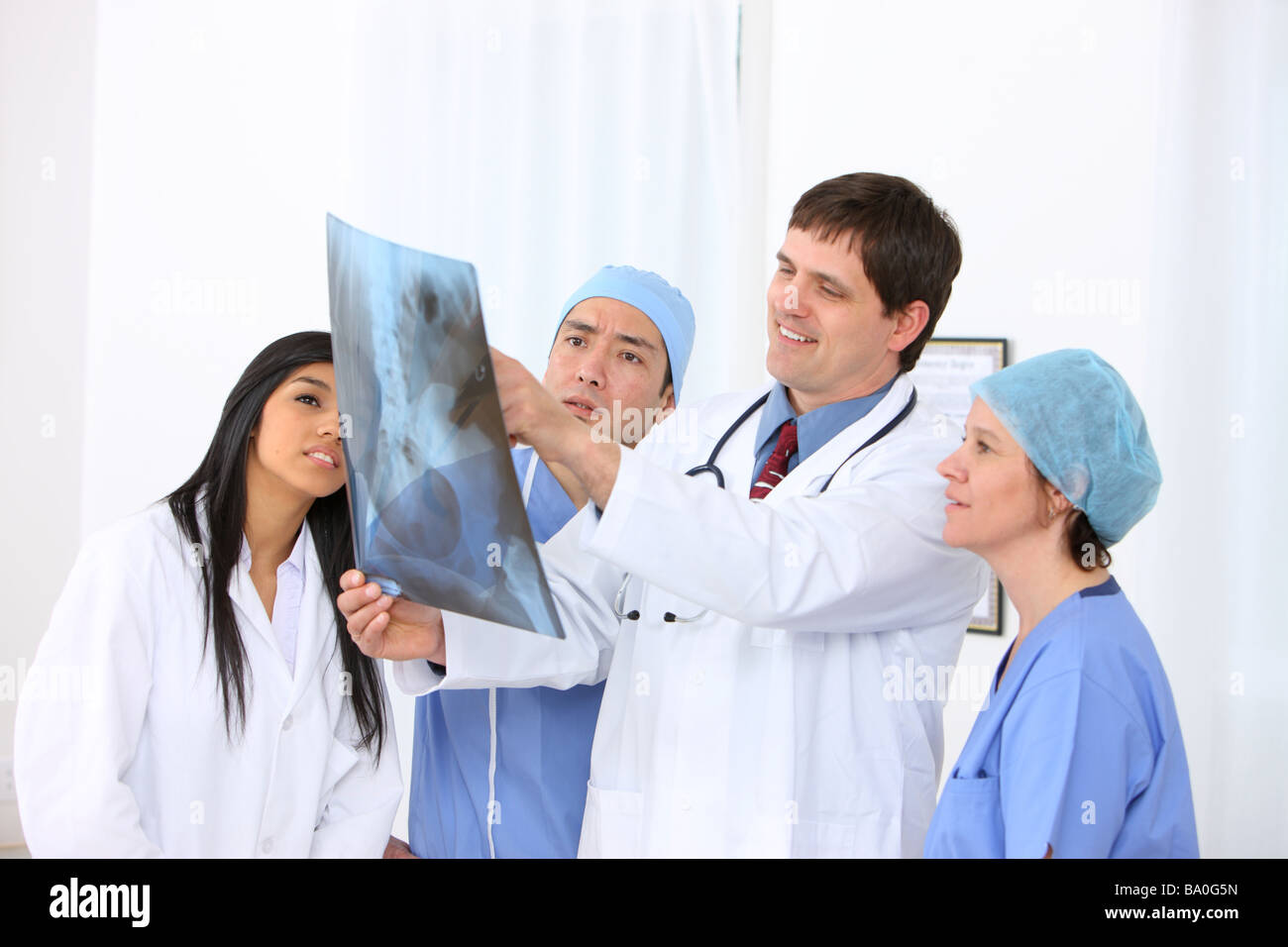 Group of medical personnel looking at x ray Stock Photo - Alamy