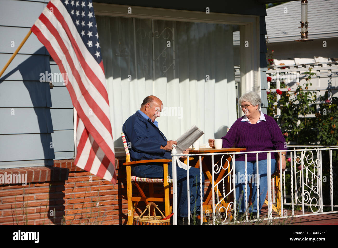 Senior couple sitting on front porch Stock Photo Alamy