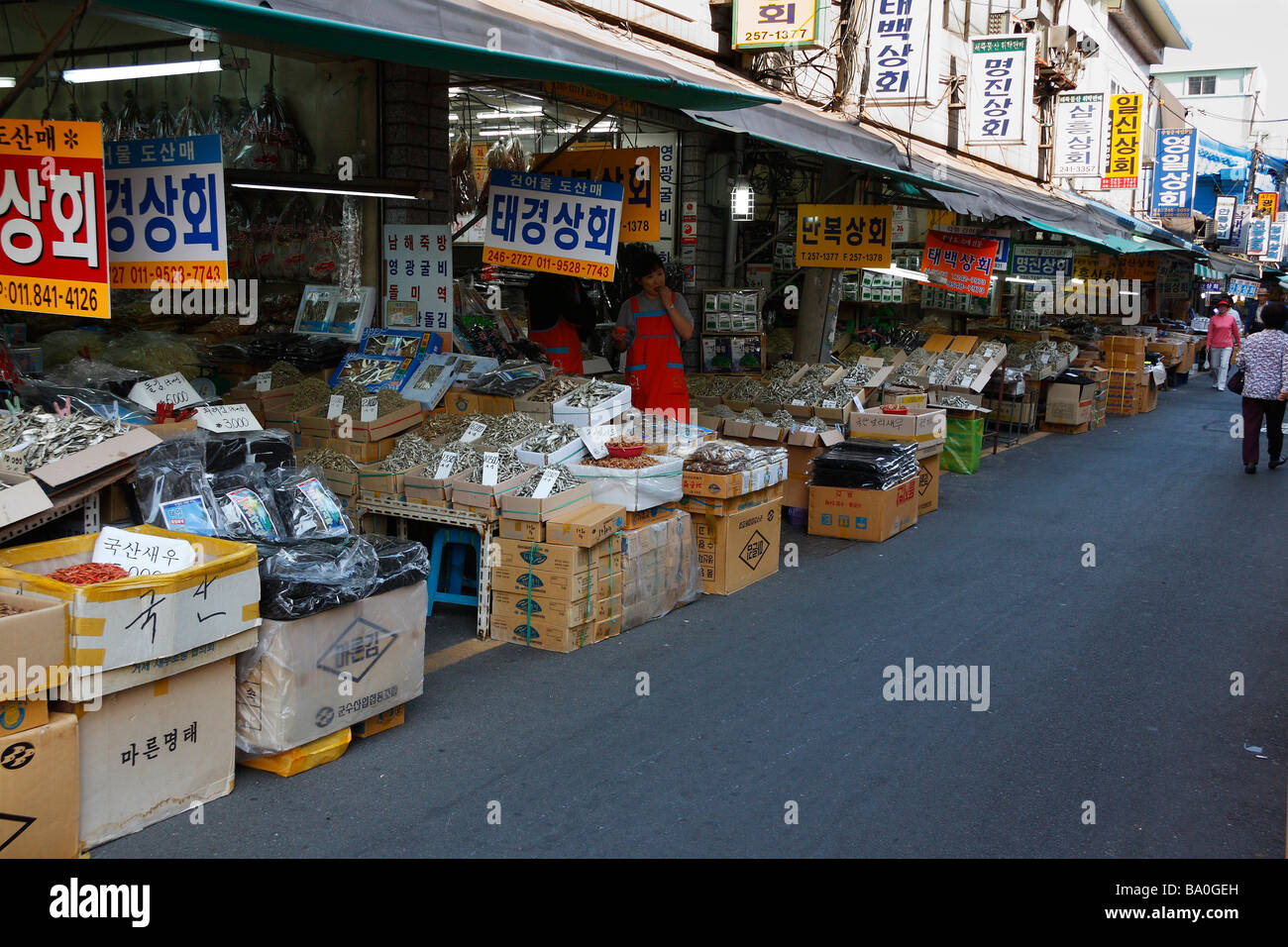 A fish market street in the city of Busan, with merchants located on the side of the street selling dried fish and sea products. Stock Photo